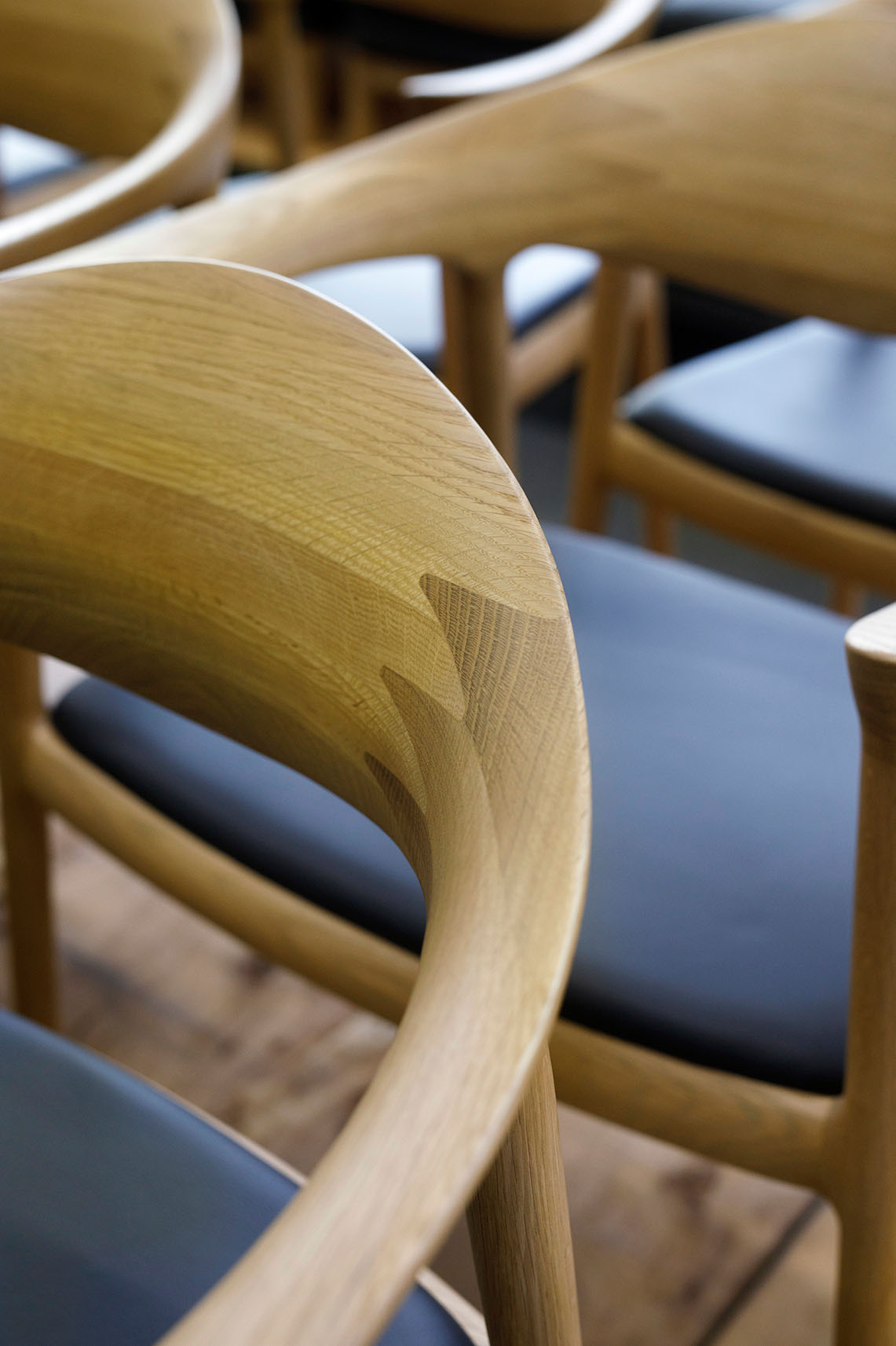 Bridge Arm Chair by Bernstorffsminde M&oslash;belfabrik featuring curved oak frame and upholstered red seat and back.