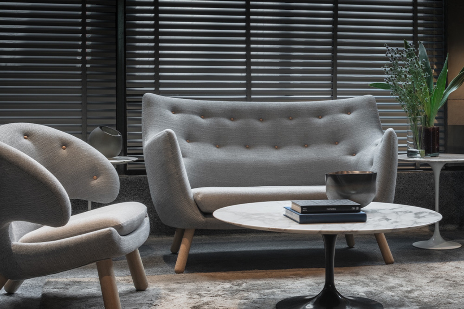 Finn Juhl 57 sofa upholstered in orange Kvadrat fabric with contrasting cushions in a minimalist interior&rdquo;