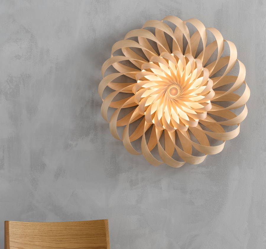 Tom Rossau TR43 double wall light with a sculptural spiral design, crafted from curved natural wood slats that radiate outward to produce a warm, layered wall glow.